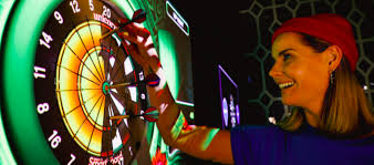 Woman enjoying Interactive Darts with electronic dartboard